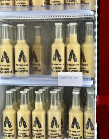Bottles of Bean Bar cold coffee lined up in the fridge