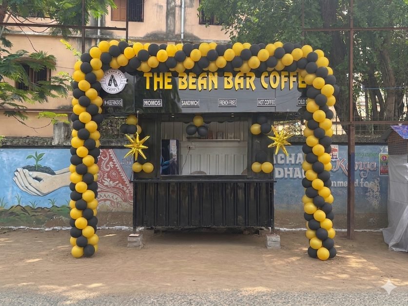Bean Bar Coffee stall decorated with black and gold balloons for launch